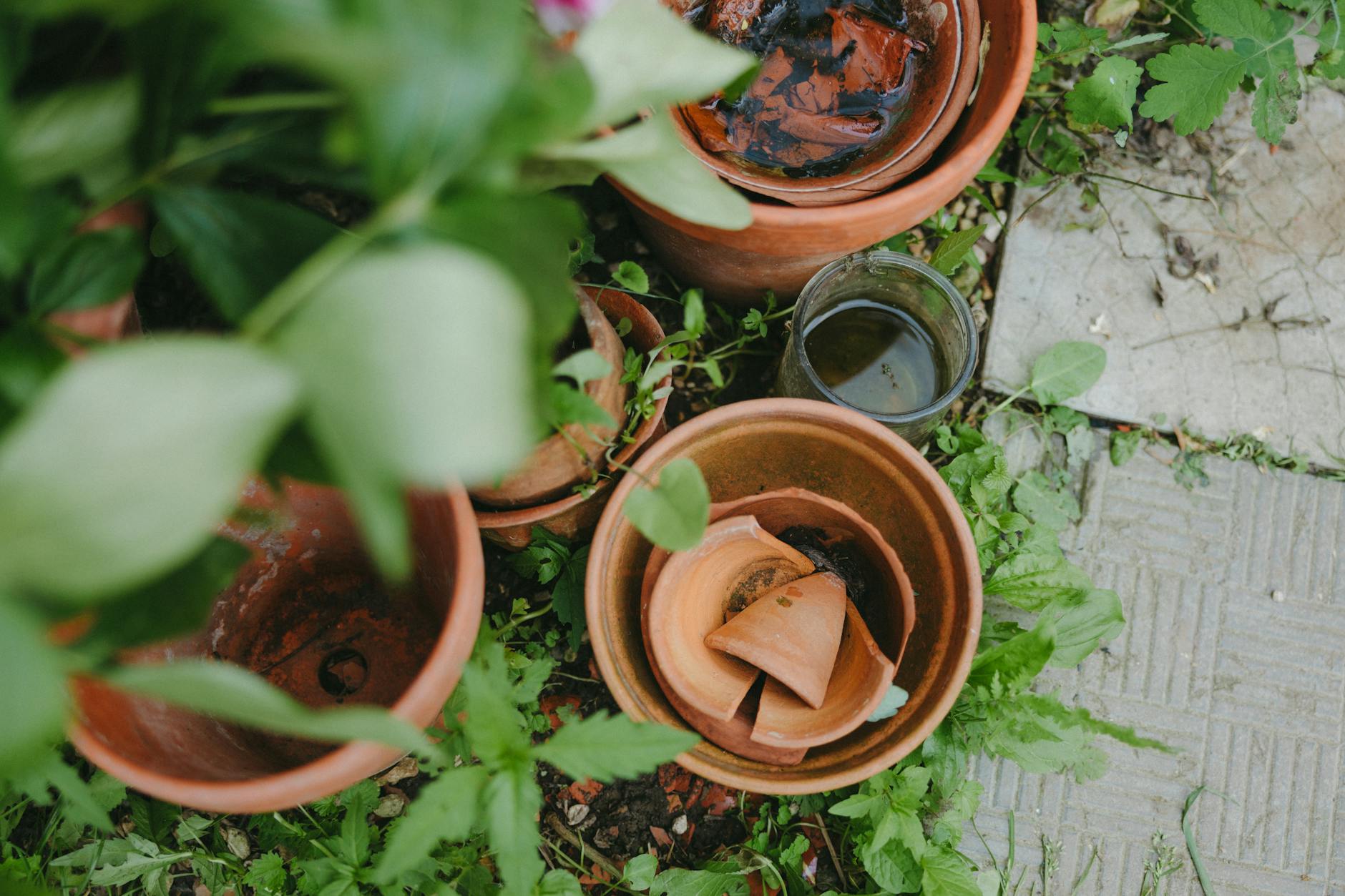 old and broken clay pots on ground