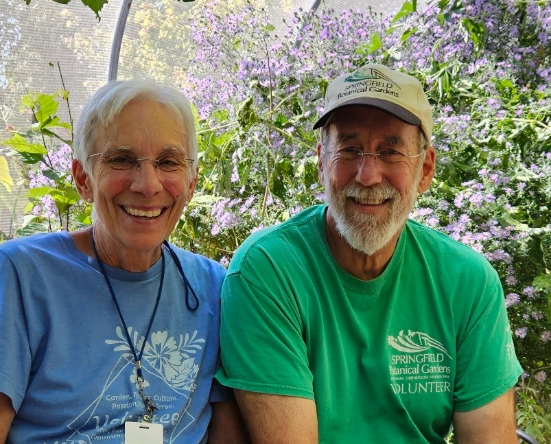 A smiling man and woman volunteer at the  Roston Butterfly House